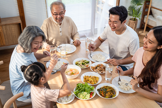 family enjoying dinner at the table in home